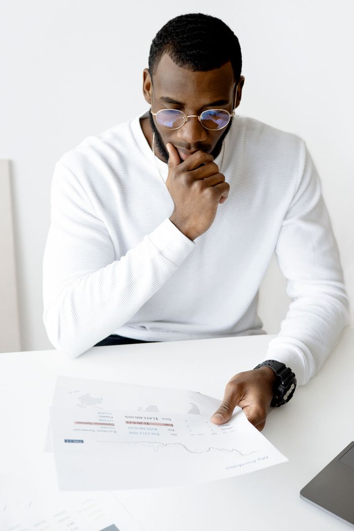 Businessman in an office setting reviews documents, indicative of focus and professionalism.