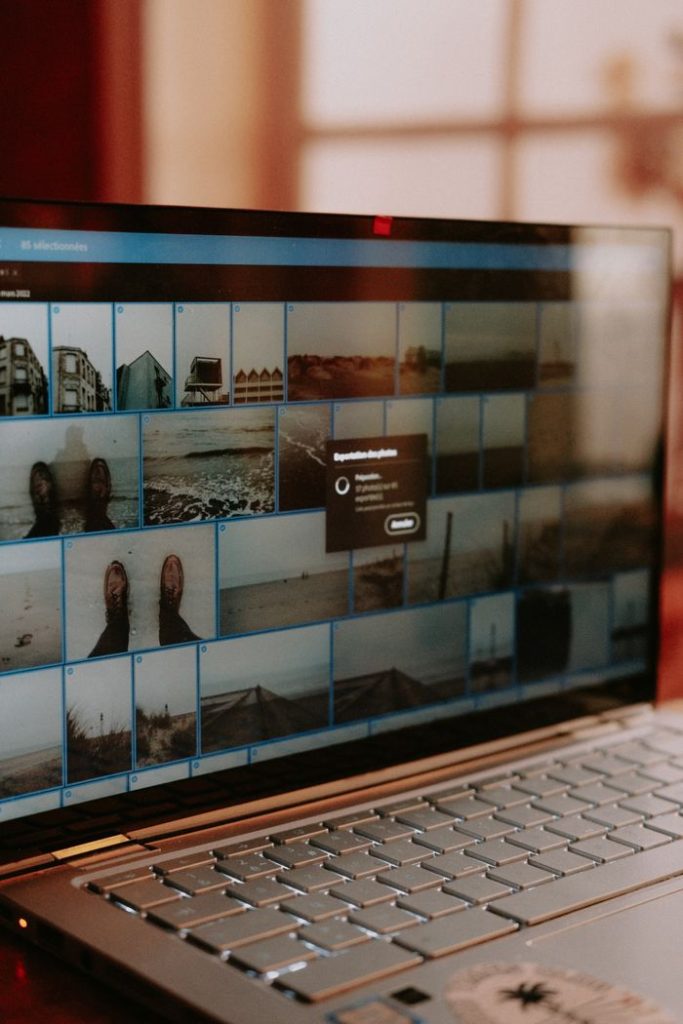 A close-up view of a laptop screen running photo editing software showcasing digital images.